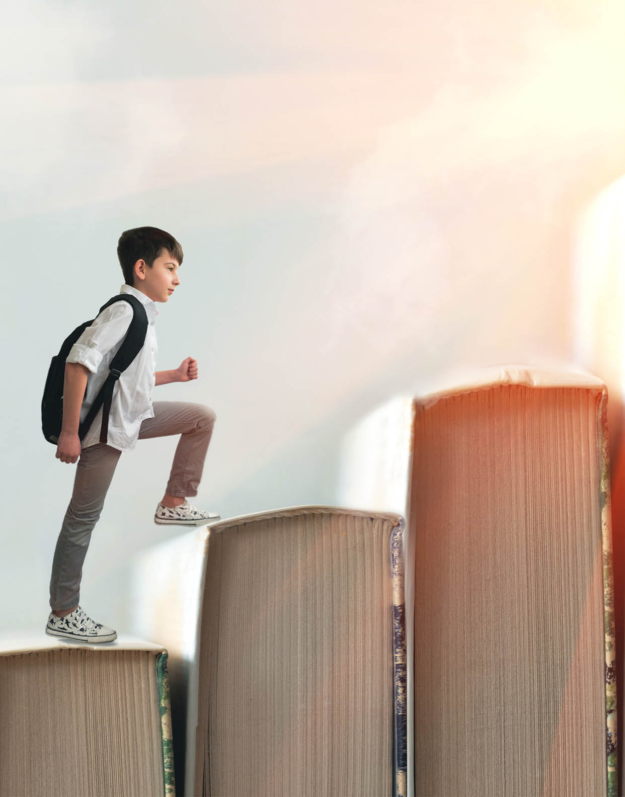 Child climbing stairs made of on sky background  Education or hard study concept  Soft focus