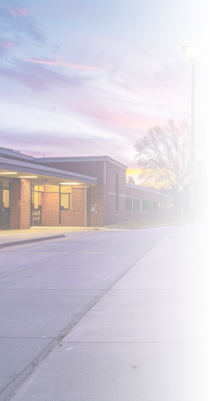 A peaceful school pathway illuminated at sunset, showcasing vibrant clouds and a playground. Perfect for educational, community, or outdoor themes.